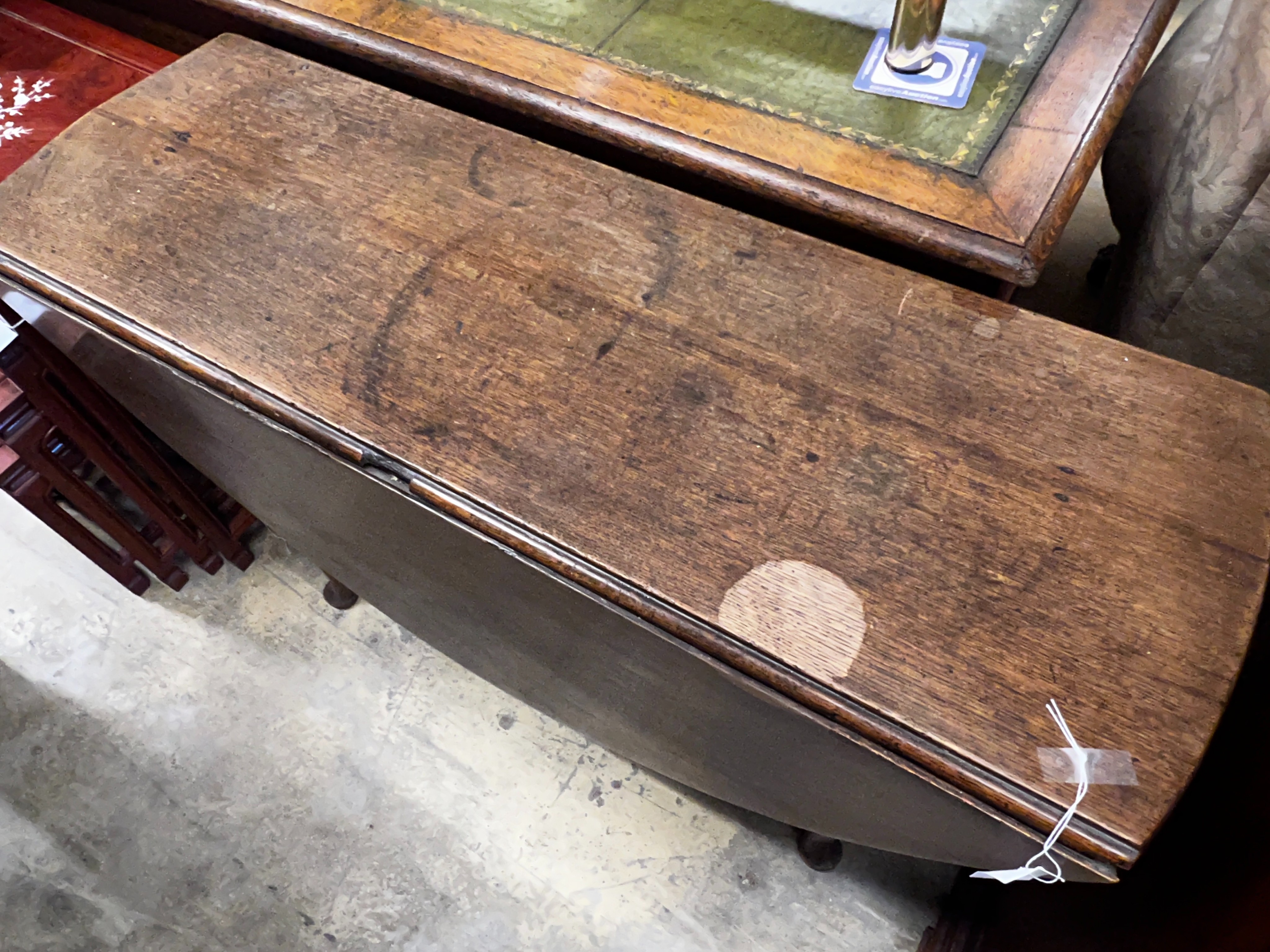 An 18th century oak drop leaf padfoot dining table, length 104cm, depth 37cm, height 72cm